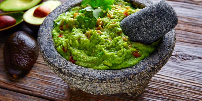 guacamole sauce served in a traditional stone bowl